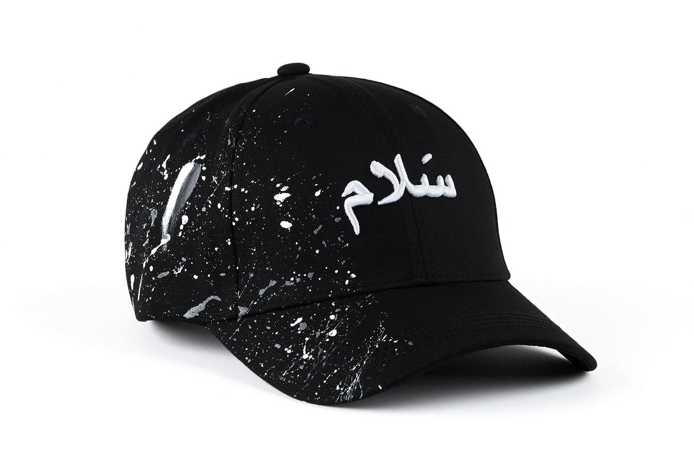 Casquette Kalam Clothing noire avec inscription en arabe Salam et peinture grise et blanche